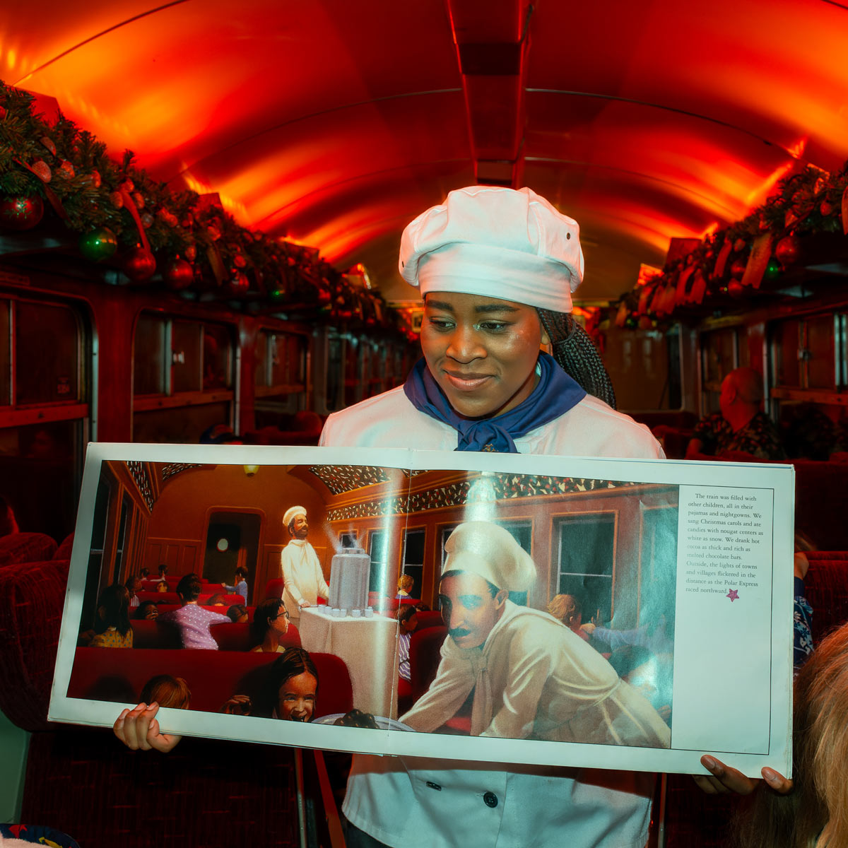 Chef holding book on board The Polar Express Train Ride