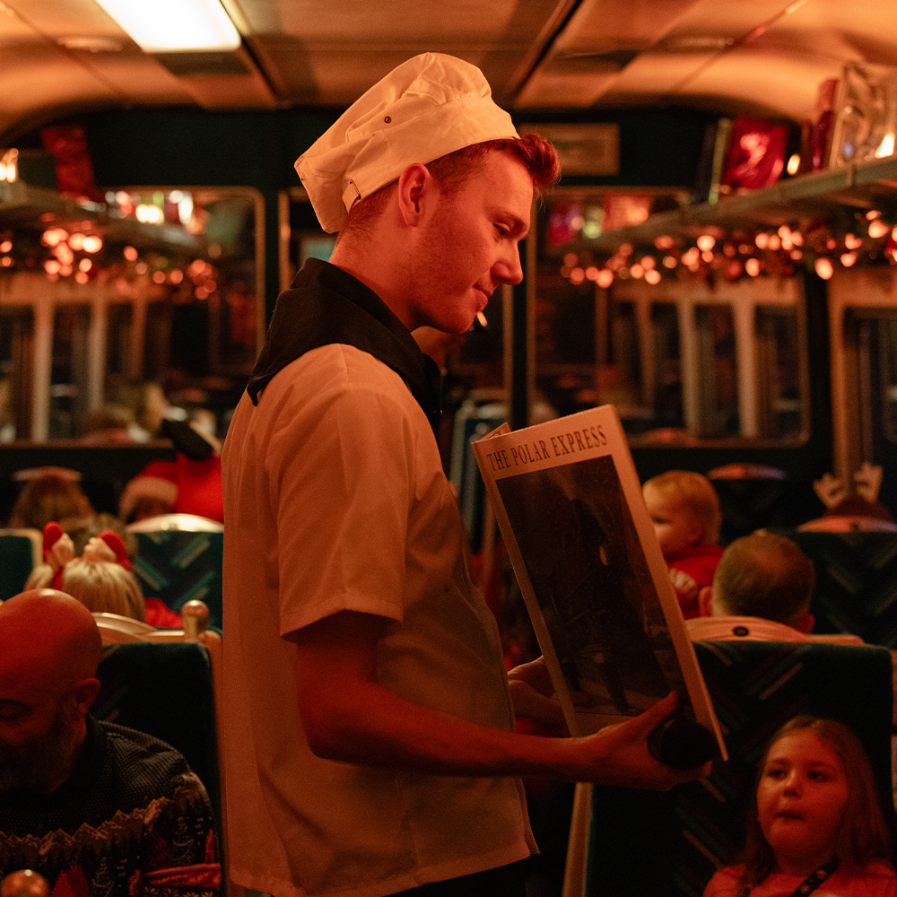 Chef on board The Polar express Train Ride holding the book