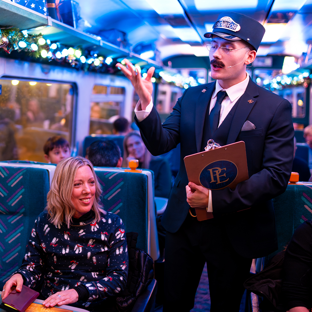 conductor talking to passengers on board the polar express train ride