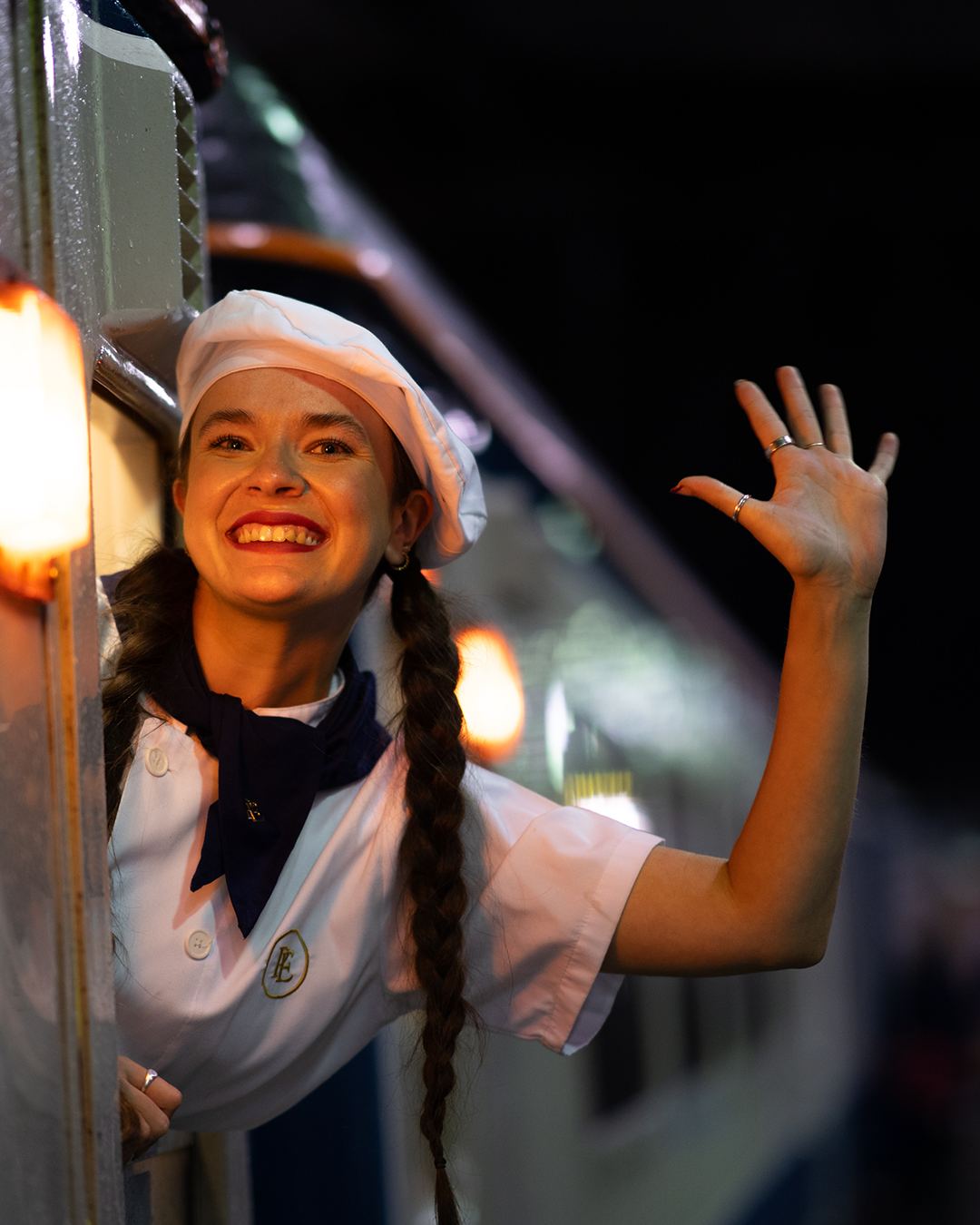 chef waving outside window on board the polar express train ride