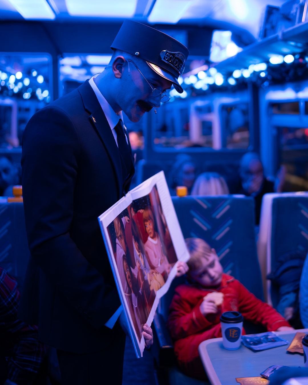 conductor holding book on board the polar express train ride
