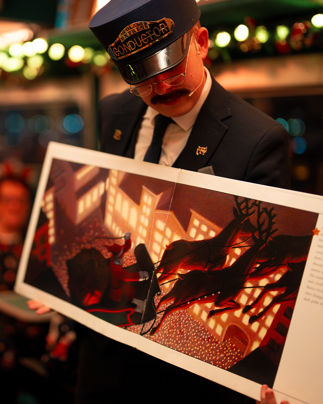 conductor with book on board the polar express train ride