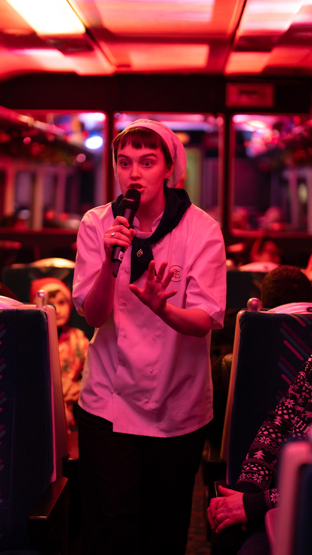 chef holding microphone on board the polar express train ride