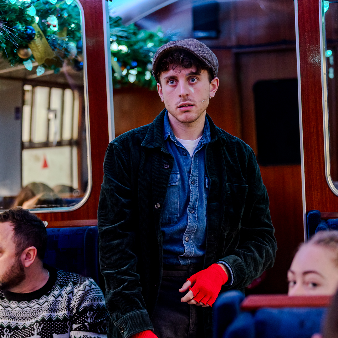 The conductor clipping tickets on THE POLAR EXPRESS™ Train Ride London