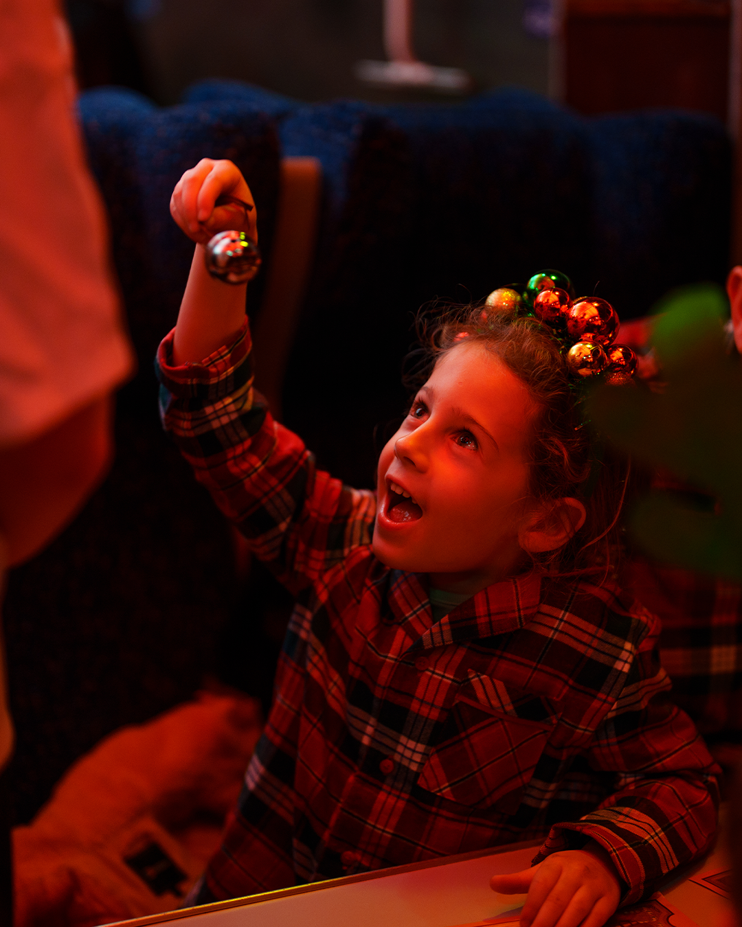 child with bell on board the polar express train ride